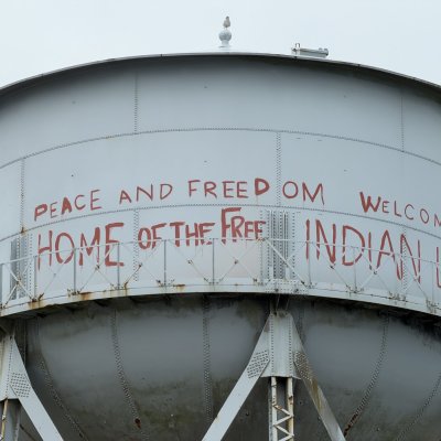 Alcatraz's water tower, painted in red with “Peace and Freedom. Welcome. Home of the Free Indian Land.”