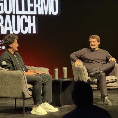 Zeno Rocha and Guillermo Rauch sitting in armchairs on stage for a fireside chat, with Guillermo's name in huge letters behind them.