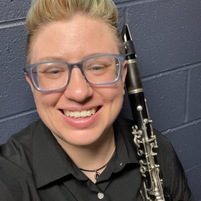 Andy smiling backstage while holding a clarinet.
